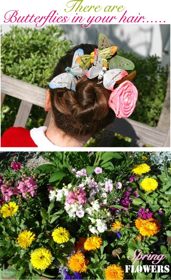 Little girl with bright colored butterflies in her hair & flower garden.