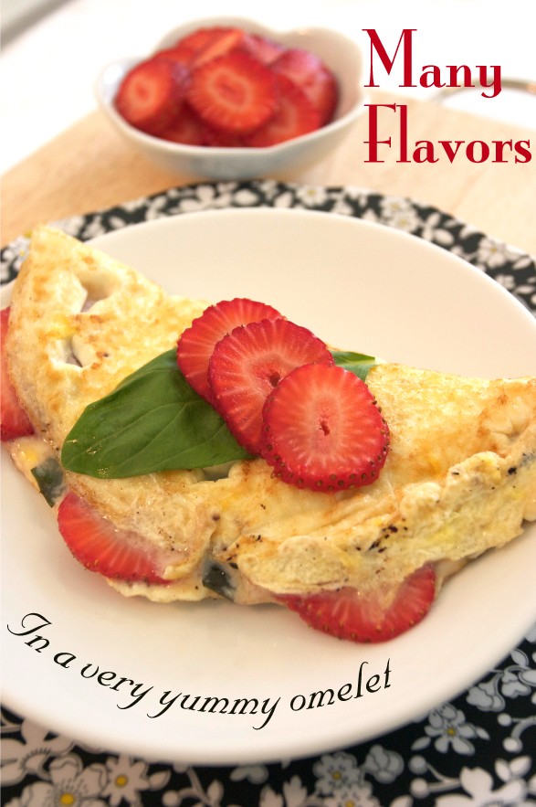 Bright colored omelet with fruit, cheese and basil