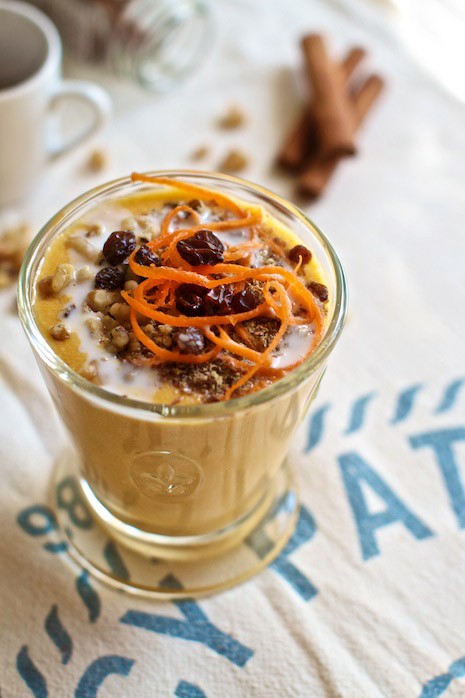 Carrot milk shake recipe in vintage glass, with raisins and walnuts.