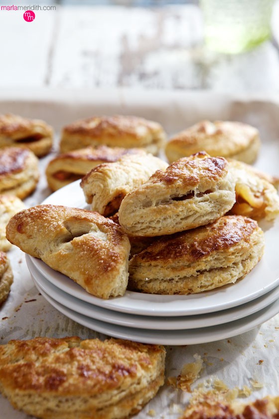 We love this Apple Turnovers recipe a delicious breakfast or brunch pastry. A buttery crust is wrapped around an irresistible apple filling. MarleMeridith.com