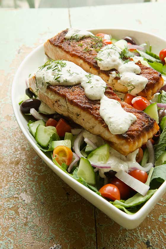 Greek salad with salmon and creamy feta dressing