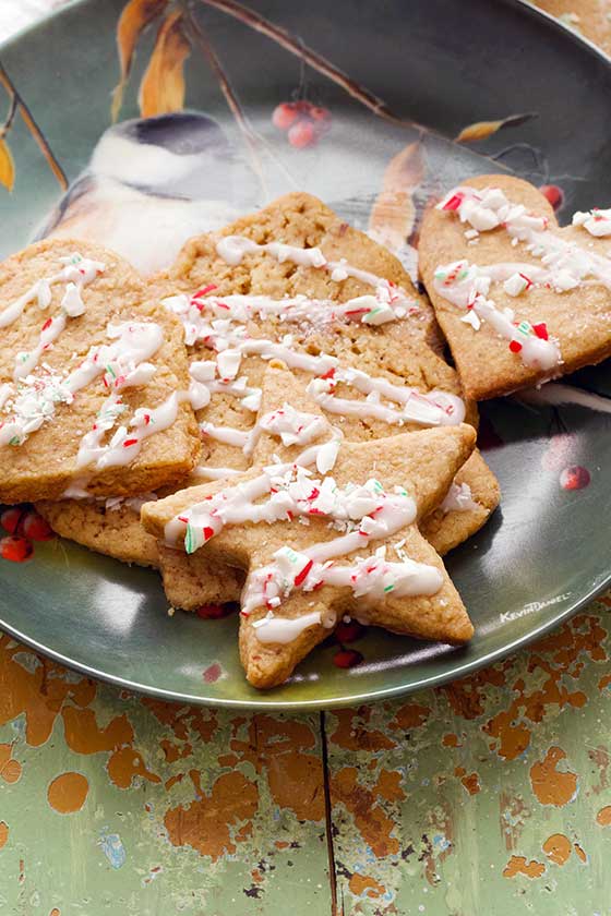 Dutch Speculaas Cookies with Peppermint Crunch Icing. Delicious traditional, thin, crisp, dark-brown cookies that originate from the Netherlands. They are extra satsifying with the festive icing! Serve for Christmas and holiday gatherings. MarlaMeridith.com